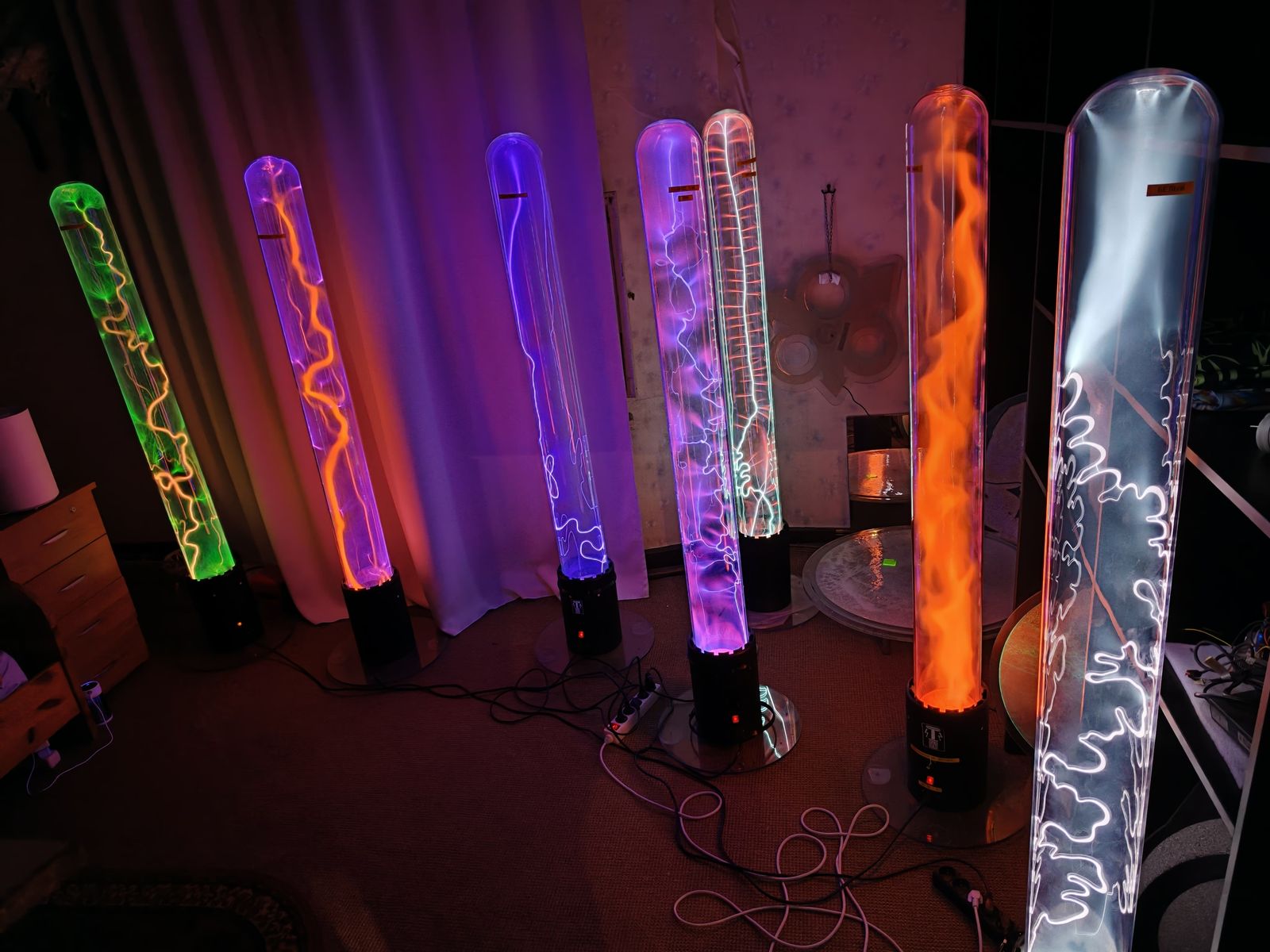 Seven plasma tubes glowing in different colors